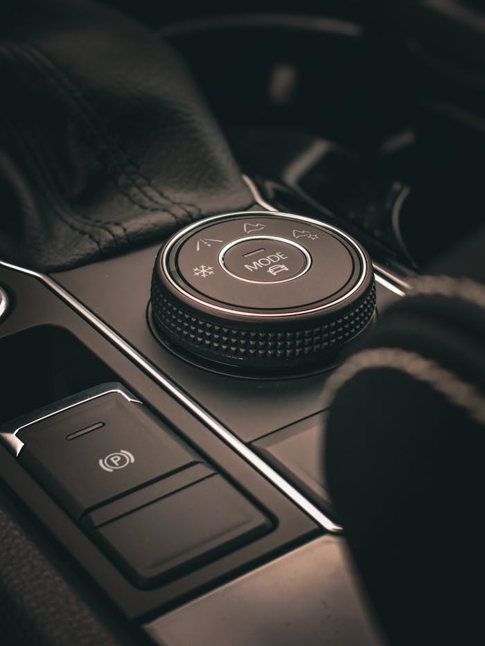 black-and-silver-round-portable-speaker-14079685 Close-up of a luxurious car interior control knob, highlighting modern automotive design.